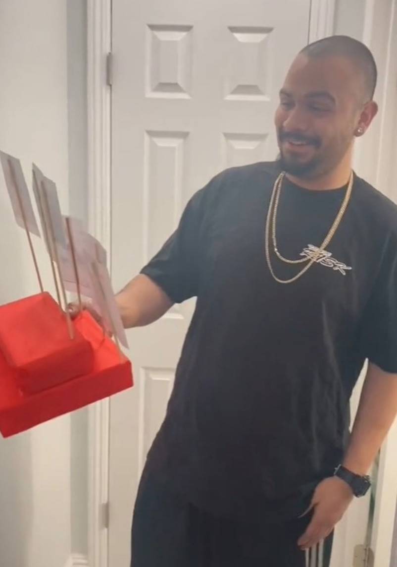 husband holding the display and smiling