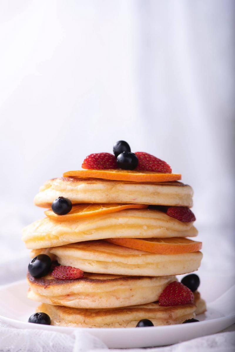 a stack of pancakes with fruit 