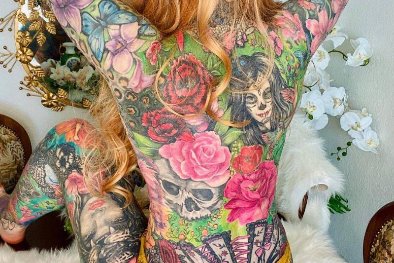 Woman's back fully covered in tattoos 