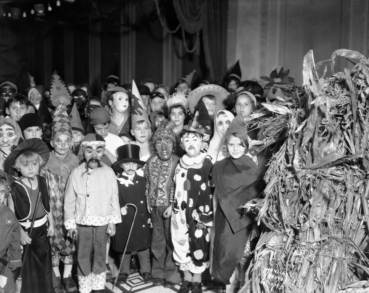 A group of school children pose for the camera wearing their Halloween costumes