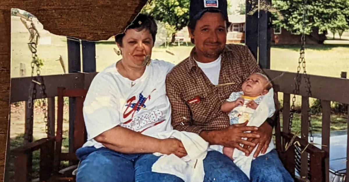 An old photograph of a middle-aged man and woman holding a baby.