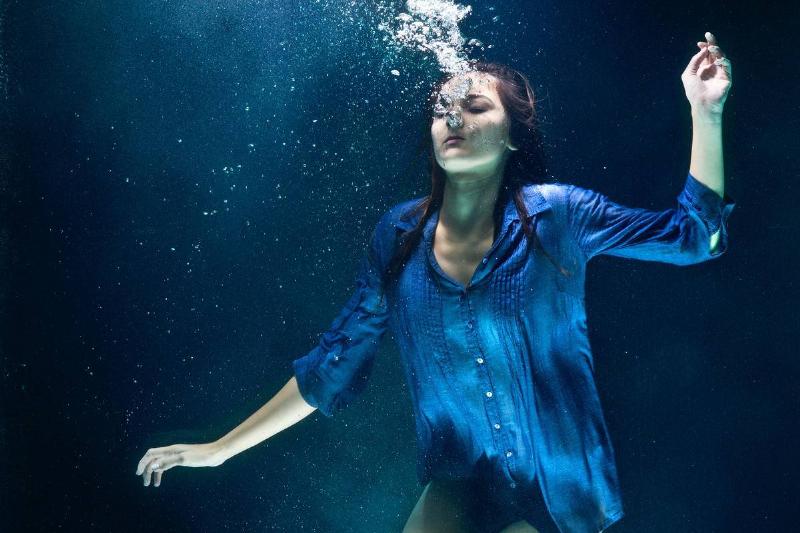 A woman drowning underwater. 