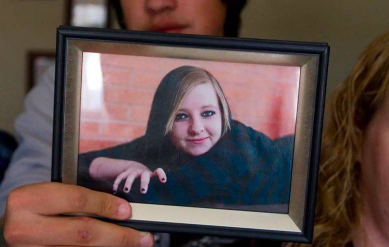 Boyfriend: Nathan Wittman, 19, holds a photo of his late girlfriend who died of cancer shortly after giving birth to their son who he now has full custody over