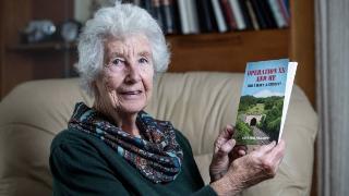 Mrs Phillips has published her husband's life story into a book, titled 'Operation XX And Me: Did I Have A Choice?'  posing holding it
