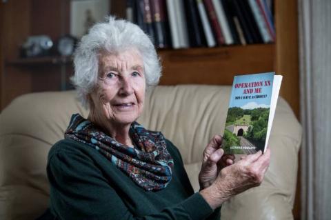 Mrs Phillips has published her husband's life story into a book, titled 'Operation XX And Me: Did I Have A Choice?'  posing holding it