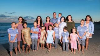 family photo on the beach with all children