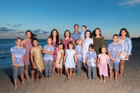 family photo on the beach with all children