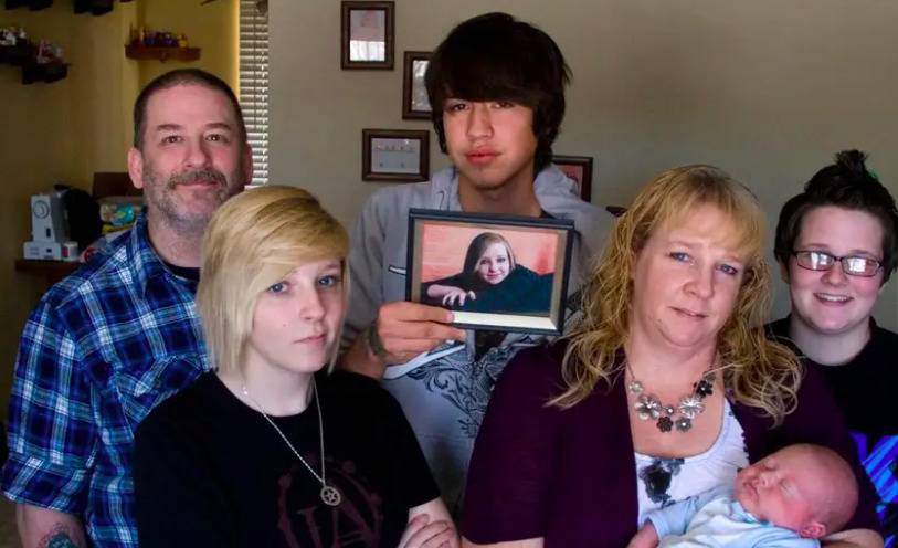 Jenni Lake's family, from left, father Mike Lake, sister Kaisee Lake, boyfriend Nathan Wittman, mother Diana Phillip with Jenni's newborn son Chad Michael Lake Wittman, and sister Ashley Lake pose for a portrait in Pocatello, Idaho on Dec. 6, 2011.