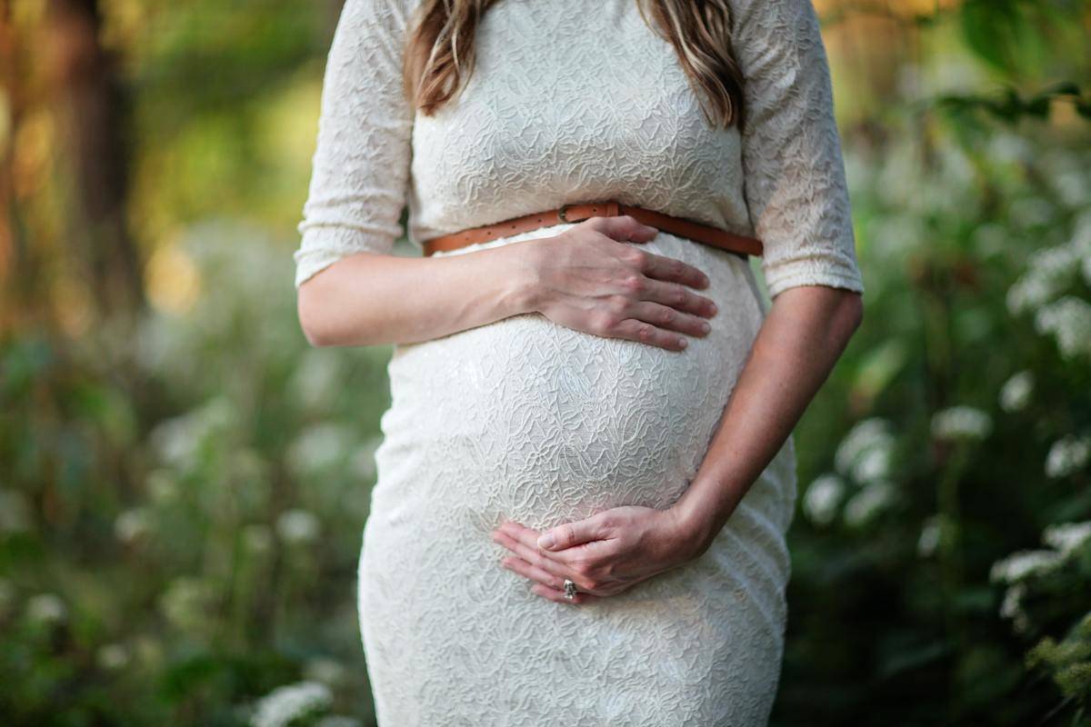 pregnant woman holding her stomach