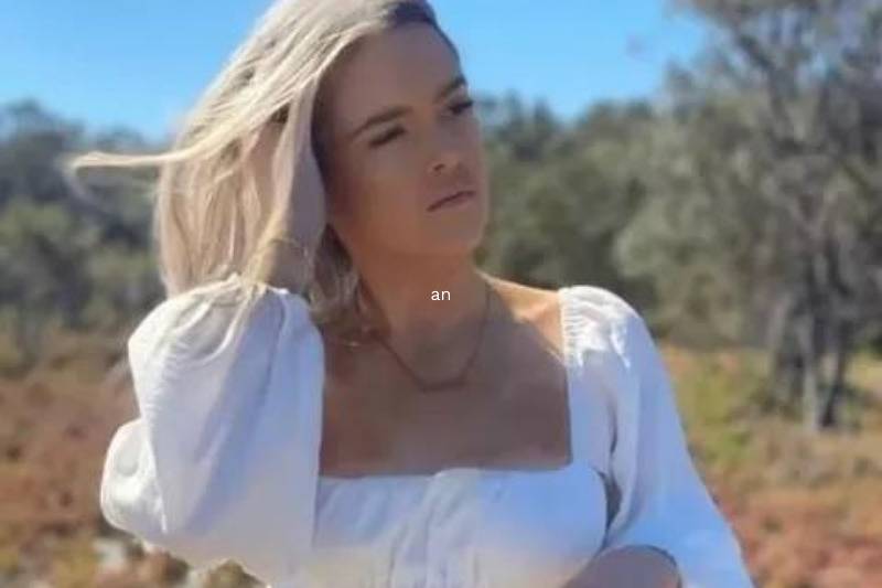 Brie posing in white shirt running fingers through her hair