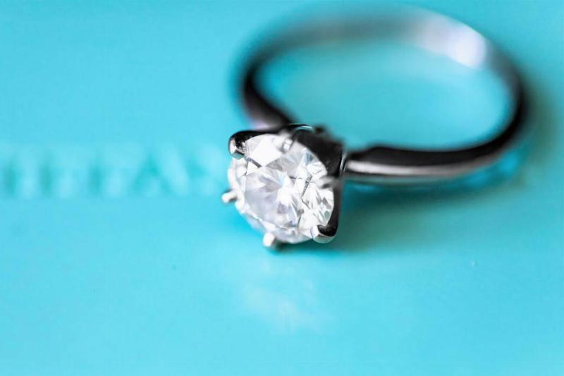 A diamond ring sitting on tiffany & co. box