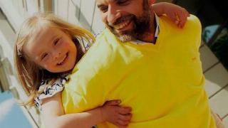 A father with his daughter on his back