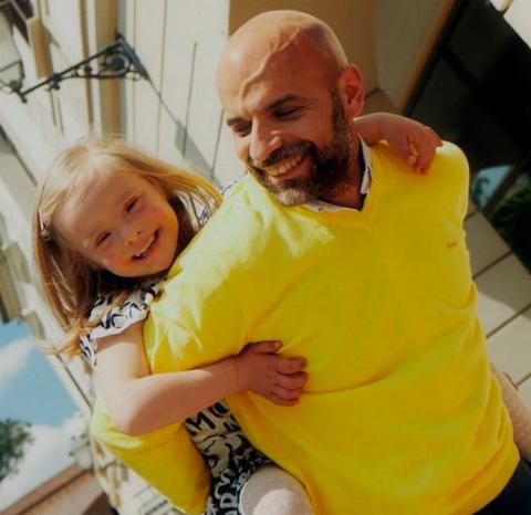 A father with his daughter on his back