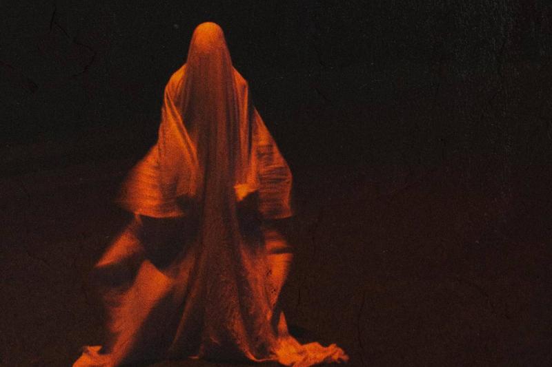 Ghost An orange-tinted photograph of a ghostly figure