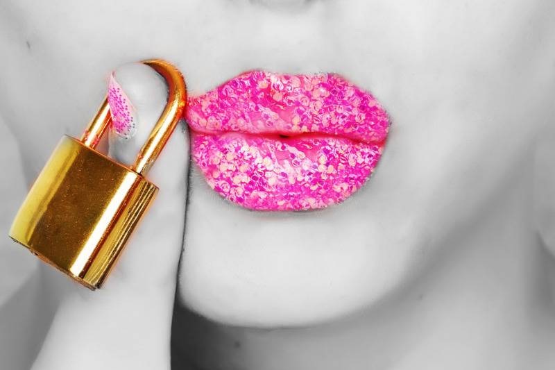 black and white face with pink lips, nail and gild lock by the lips
