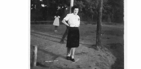 A black and white photograph of a lady with a shadow figure in the background.