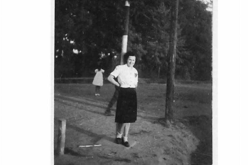 Old photograph A black and white photograph of a lady with a shadow figure in the background.