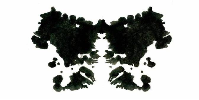 A black and white image made out of inkblots.