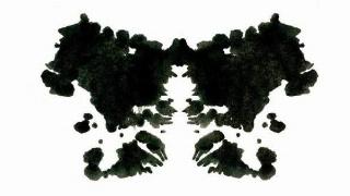 A black and white image made out of inkblots.