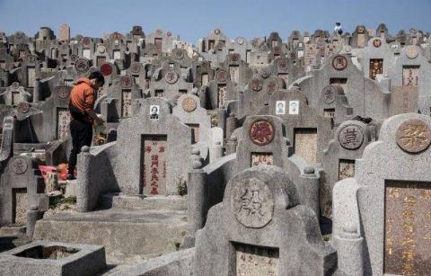 man stands at burrial site