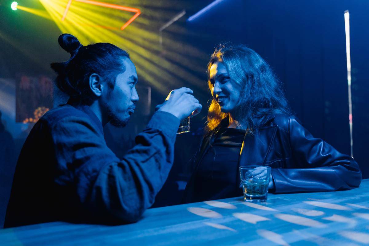 couple talk at the bar under fluorescent lighting