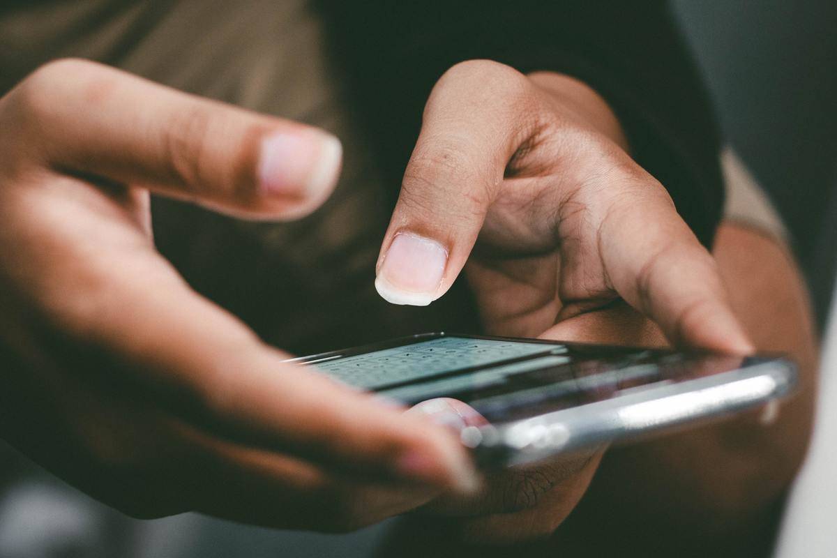 close up of hand texting