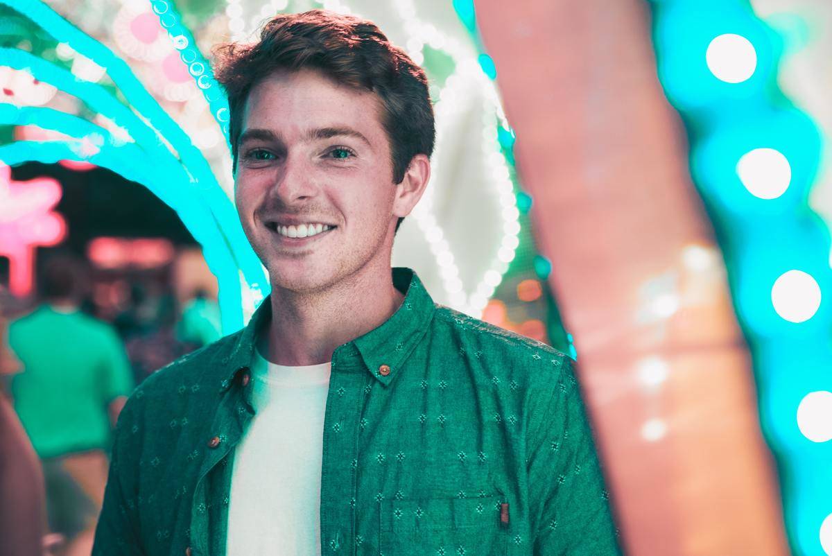 man smiling at arcade