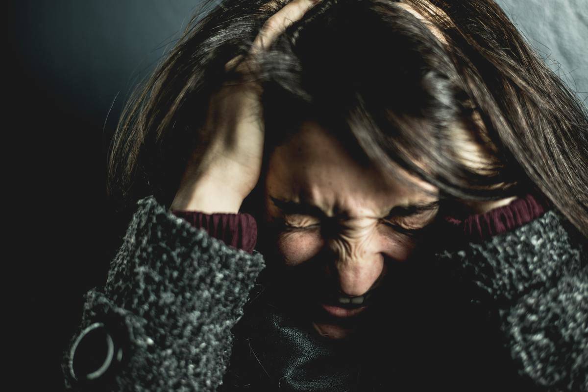 Anxious woman running her fingers through her hair