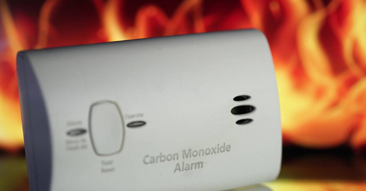 Carbon Monoxide Detector by fire background