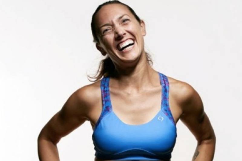 Colleen smiling in sports bra