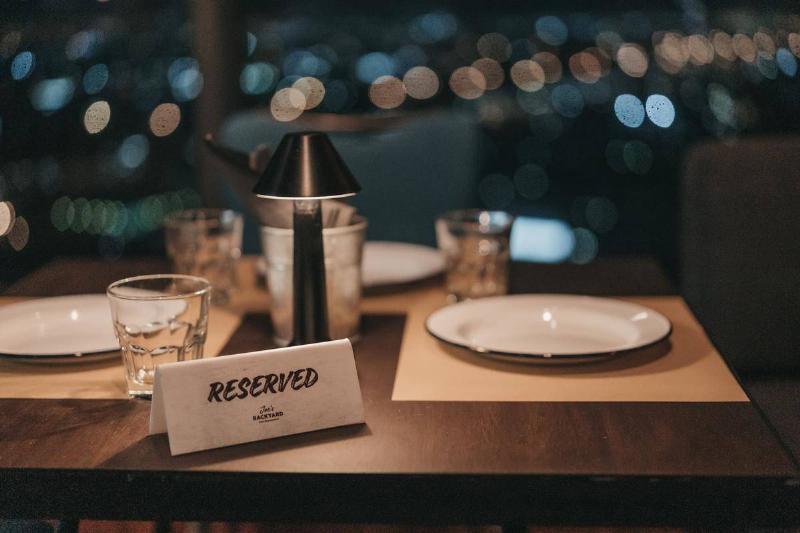 A restaurant table with a reserved sign on it.