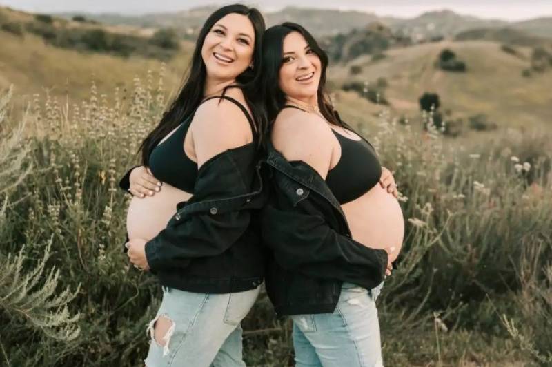 Jill, left, and Erin standing back to back 