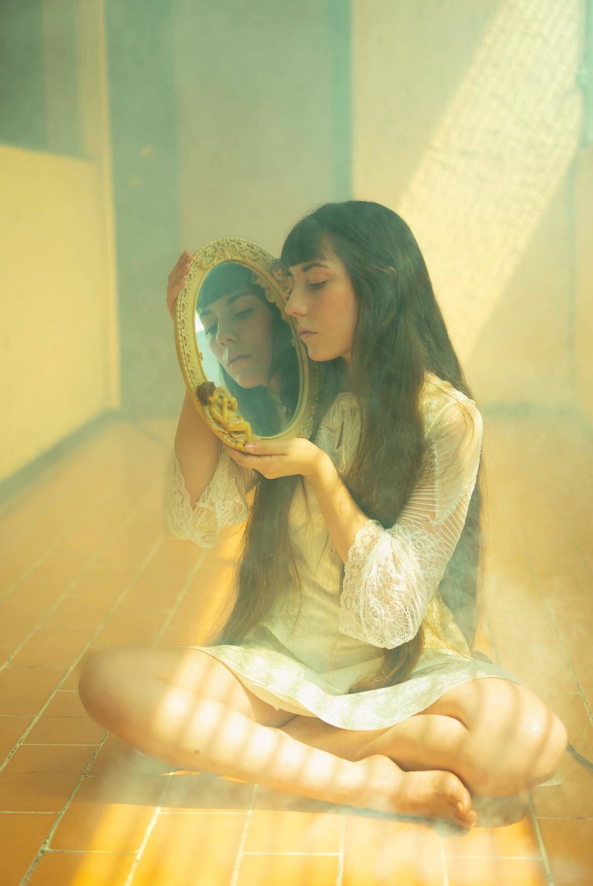 oung-girl-with-long-black-hair-looking-in-mirror