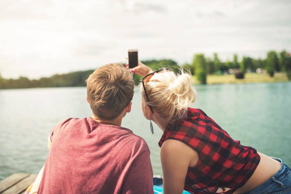 couple take selfie by the lake