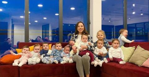 mama sits with all babies on the couch