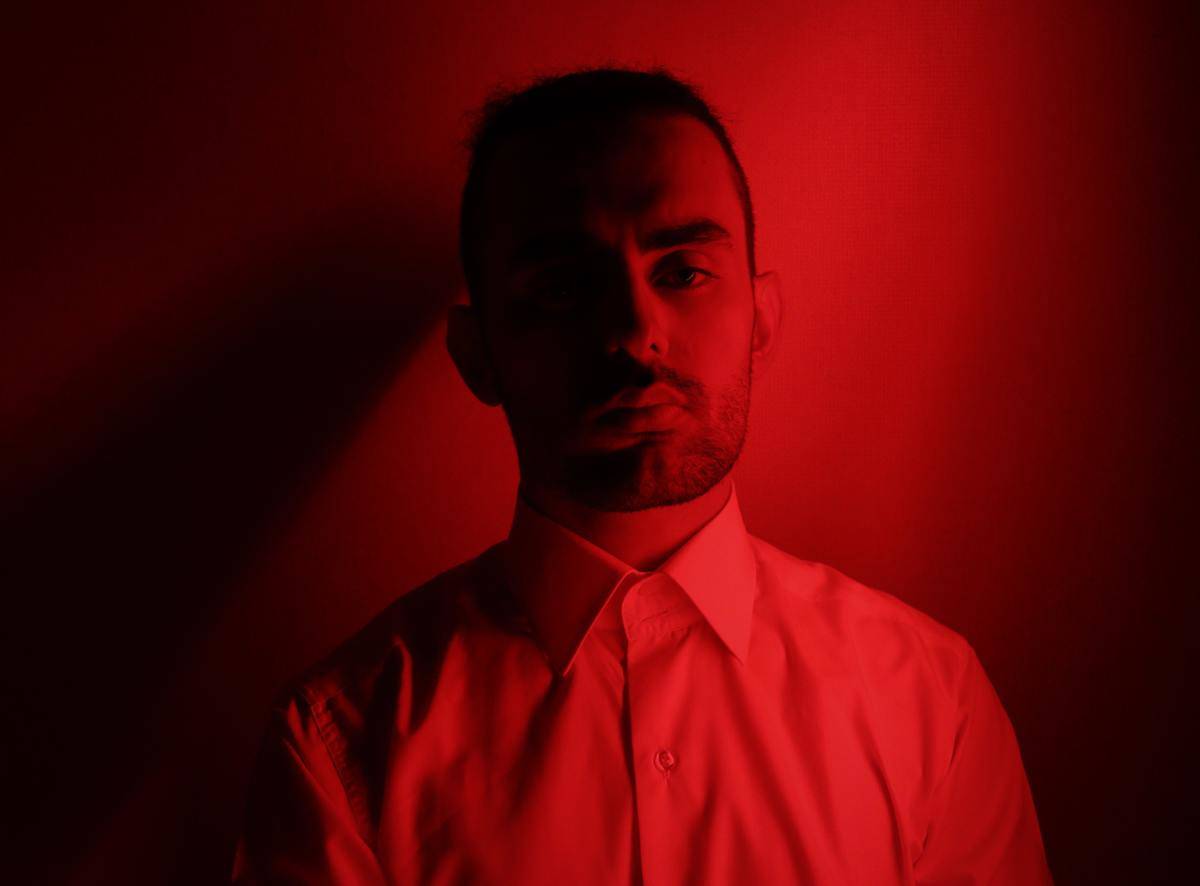 man in red lighting not smiling