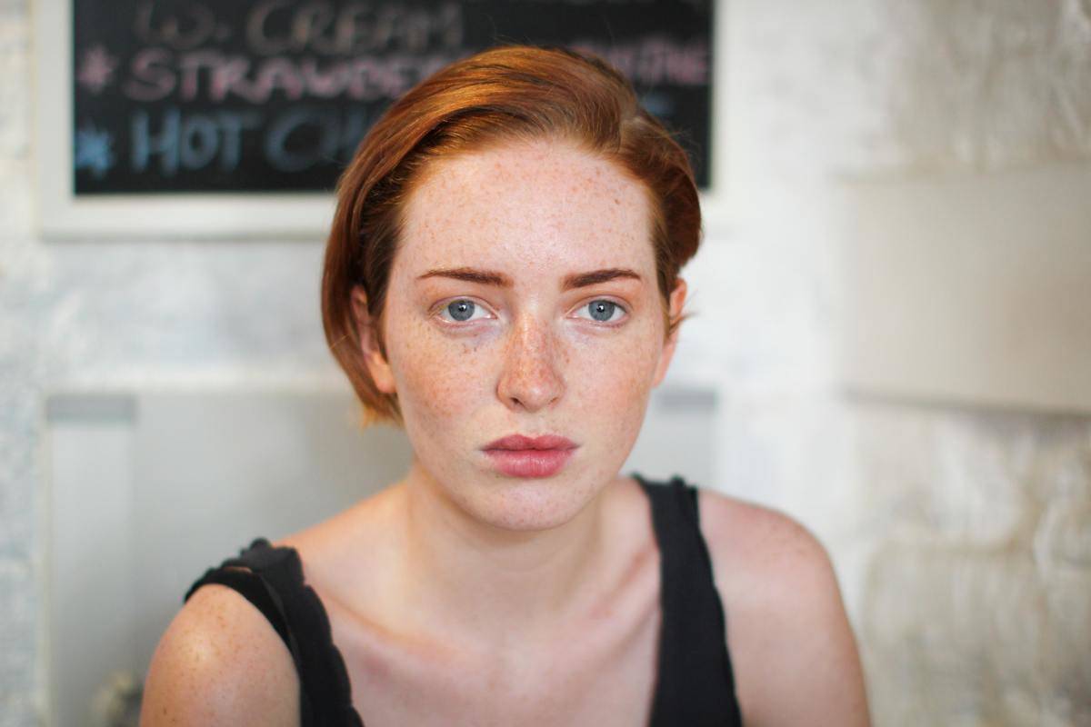 headshot of redhead woman with freckles