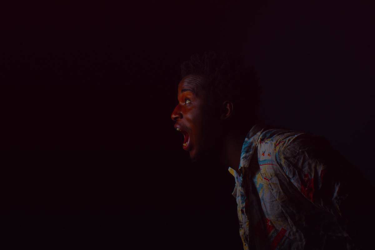 man-with-mouth-open on dark background