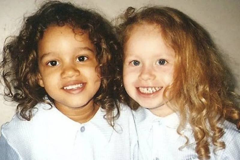 twins as toddlers smile for photo