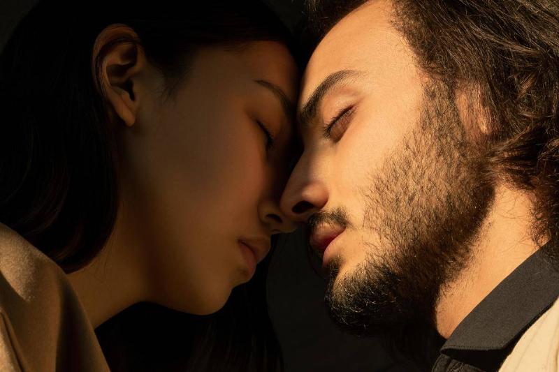woman and man standing forehead to forehead with their eyes closed
