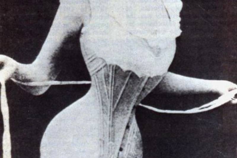 woman with corset tightening it