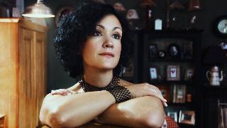 woman with crosses arms looks away