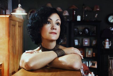 woman with crosses arms looks away