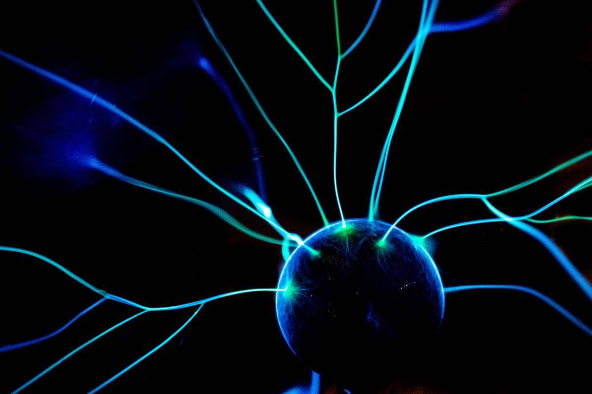 A dark blue ball of energy radiating electricity on a black background.