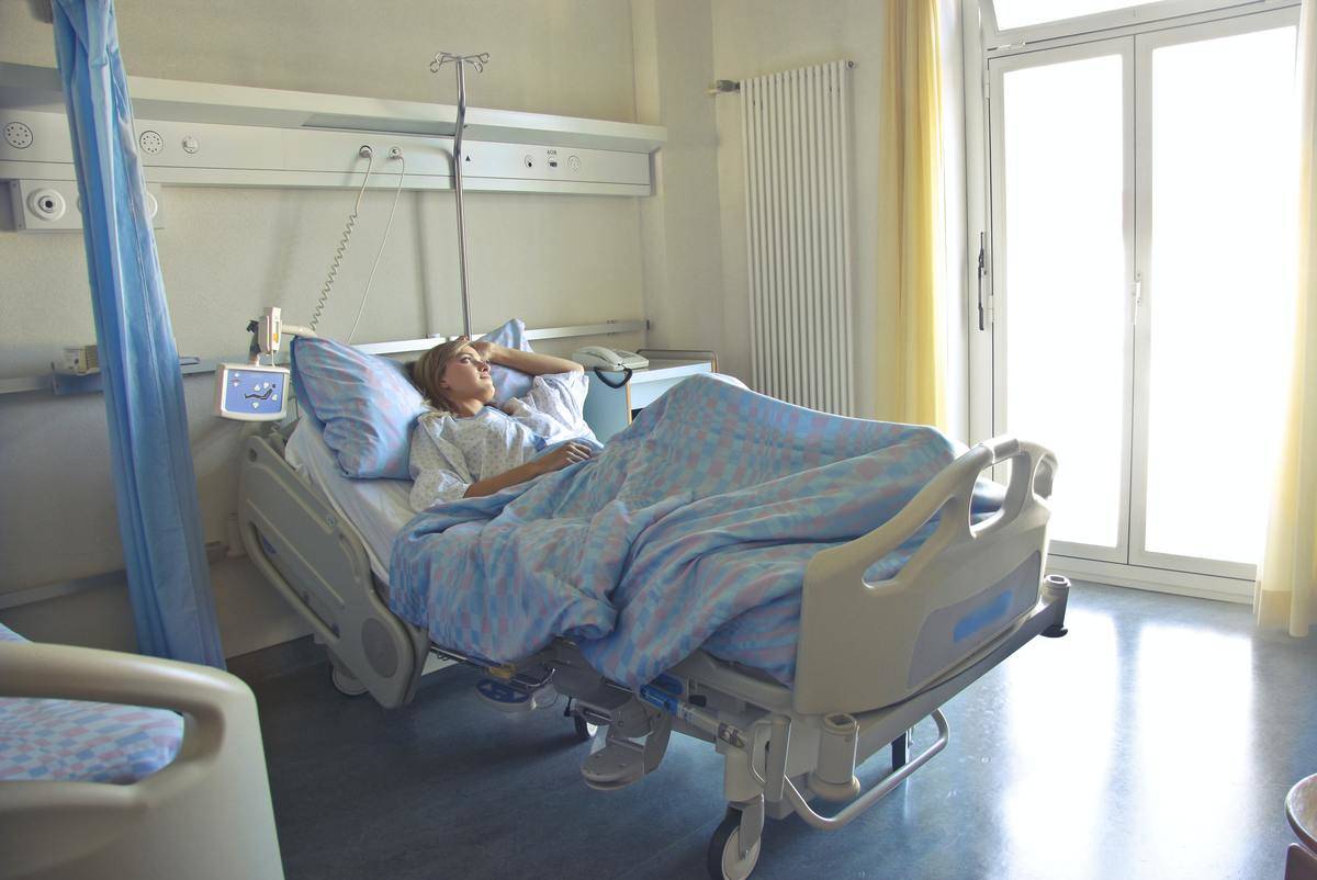 A woman laying in a hospital bed.