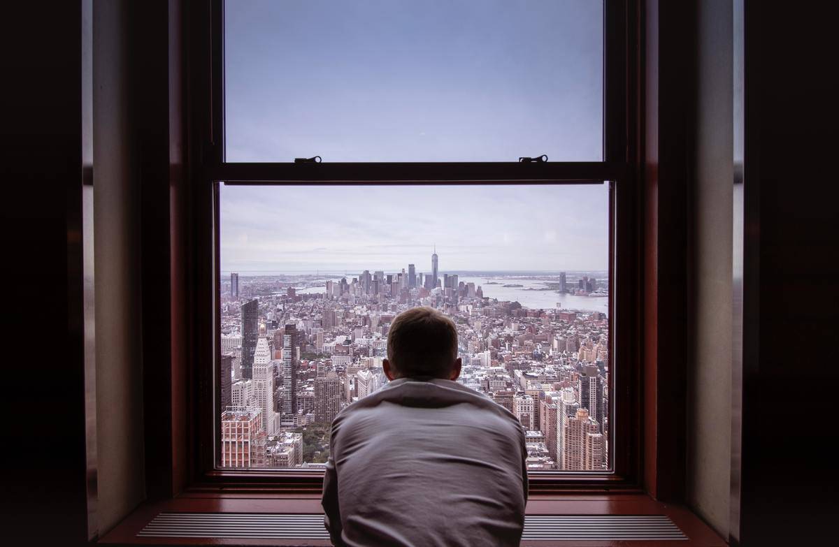 man-in-gray-shirt-looking-at-city-buildings