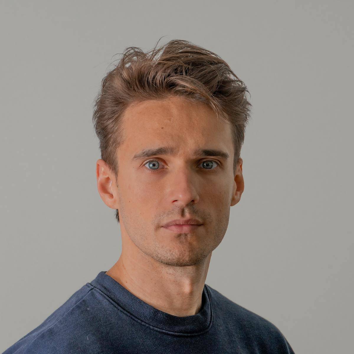 Man's face with blue eyes and blue shirt