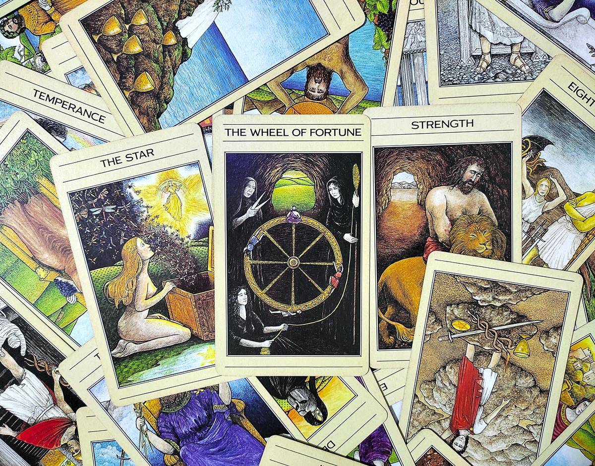 Tarot Cards Pile showing the star, wheel of fortune and strength