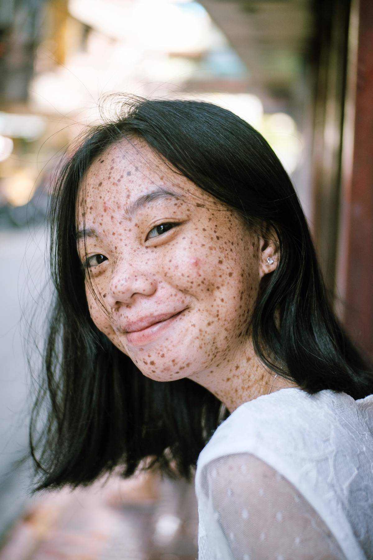Asian woman with freckles smiling