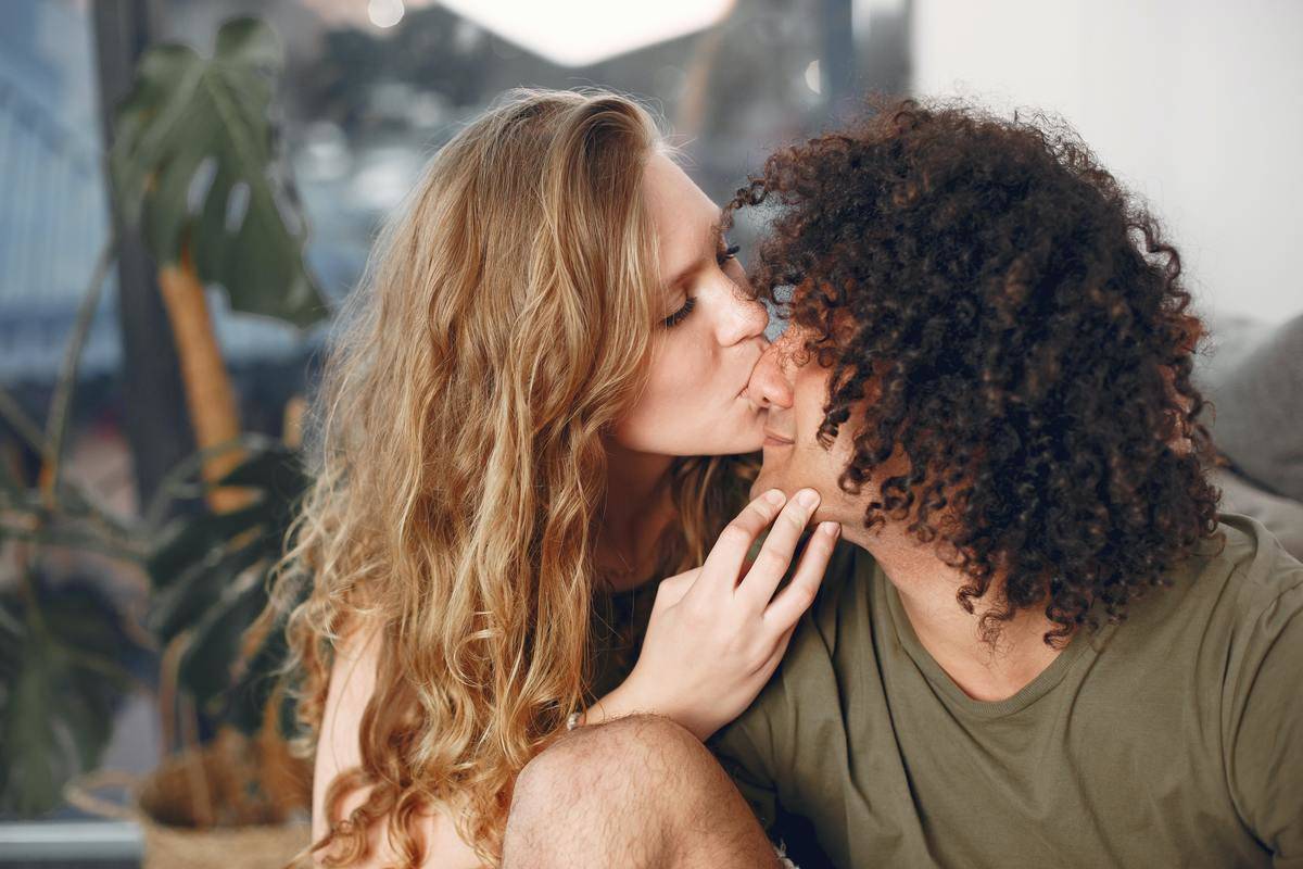 woman kisses man on the cheek